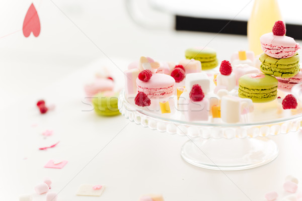 French macaroons, berries and marshmallows on the table Stock photo © deandrobot