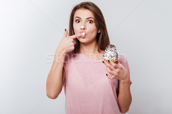 Funny woman eating cake Stock photo © deandrobot