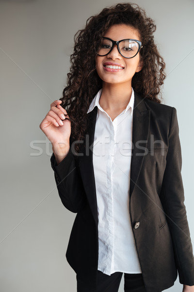 Happy african business lady wearing glasses Stock photo © deandrobot