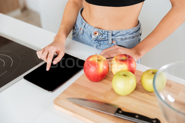 Top view of woman using tablet computer Stock photo © deandrobot