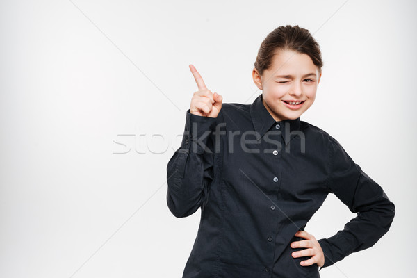 Happy young girl posing and pointing Stock photo © deandrobot