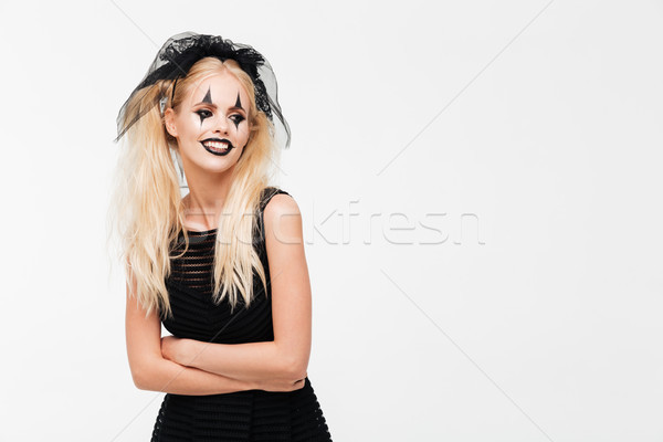 Happy blonde woman dressed in black widow costume posing Stock photo © deandrobot