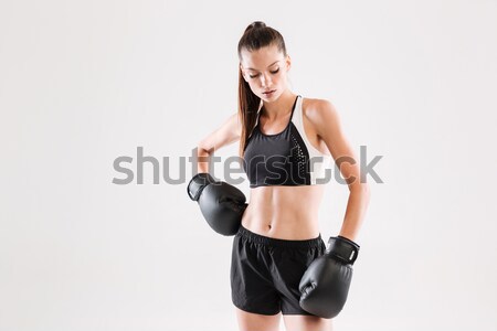 Portrait of a attractive healthy sportswoman in boxing gloves Stock photo © deandrobot