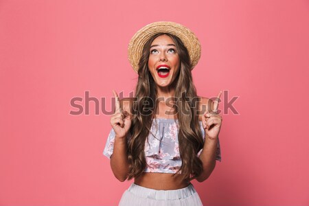 Happy woman screaming isolaed over pink Stock photo © deandrobot