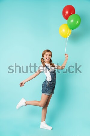 Full length portrait of an excited young woman Stock photo © deandrobot