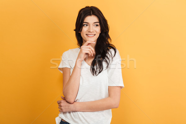 Happy young pretty woman looking aside. Stock photo © deandrobot