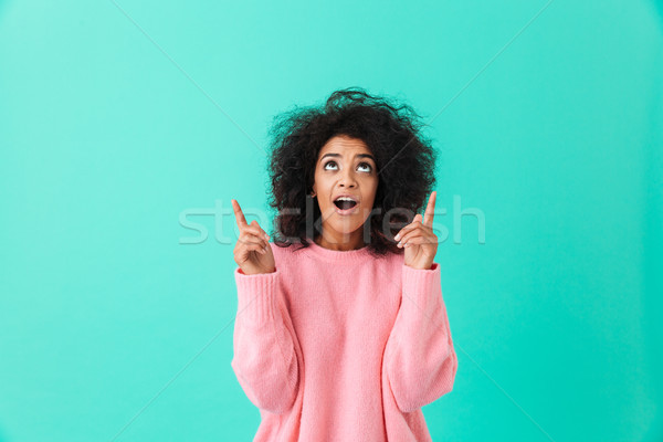 Image of lovely brunette woman in pink shirt looking upward and  Stock photo © deandrobot