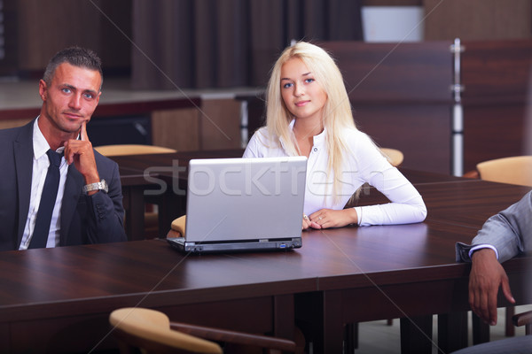 Sorridente trabalhando pessoas sessão reunião de negócios escritório Foto stock © deandrobot