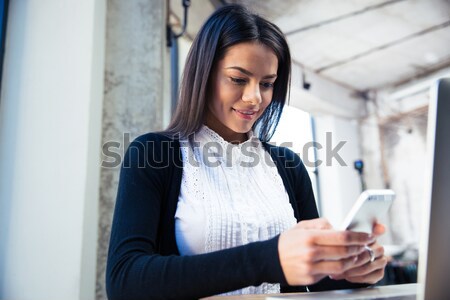 Happy businesswoman talking on the phone Stock photo © deandrobot