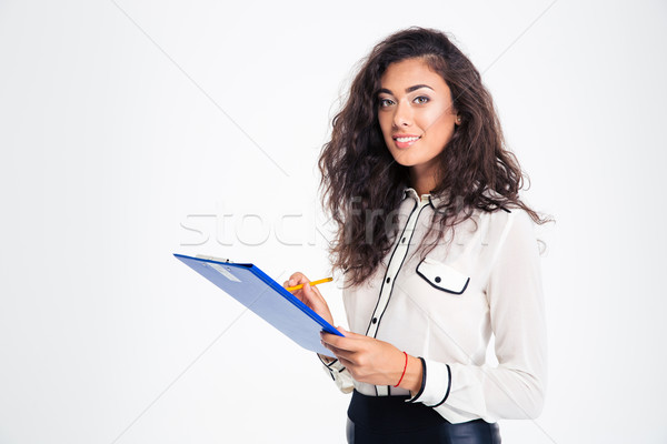 Happy businesswoman holding clipboard Stock photo © deandrobot