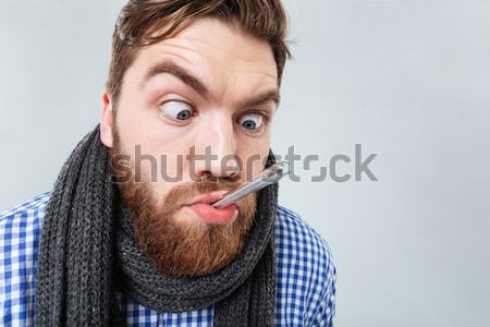 Crazy man joking and grimacing over black background Stock photo © deandrobot