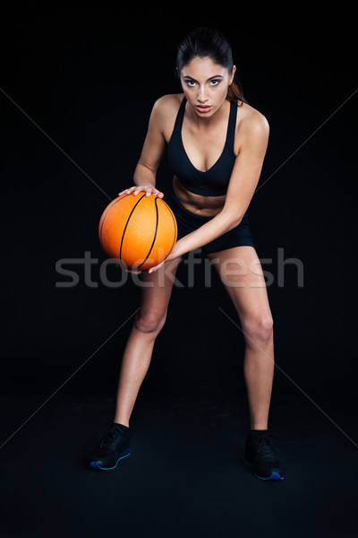 Beautiful focused sportswoman with ball ready to play basketball  Stock photo © deandrobot
