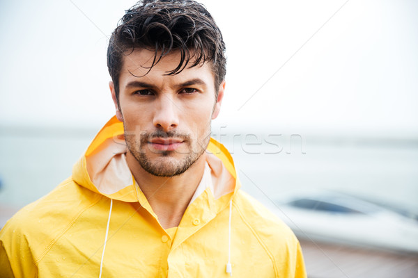 Close up portrait of a sailor man in yellow cloak Stock photo © deandrobot