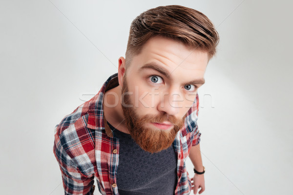 Portrait of a young suspecious man looking closely at camera Stock photo © deandrobot