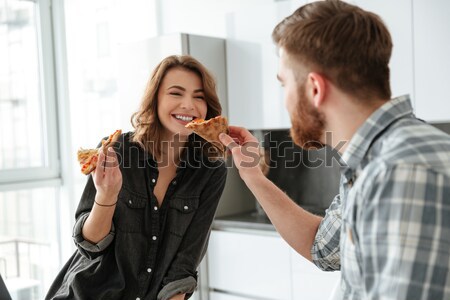 Stock photo: Happy loving couple eating pizza.