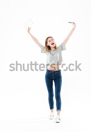 Full-length shot of young smiling girl showing at copy space Stock photo © deandrobot