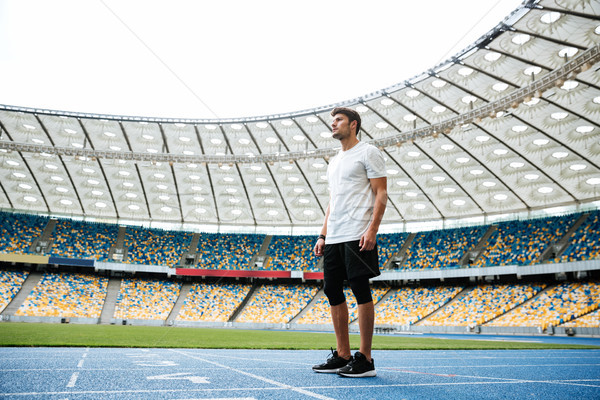 Stock photo: Full length of a young sportsman standing on a racetrack