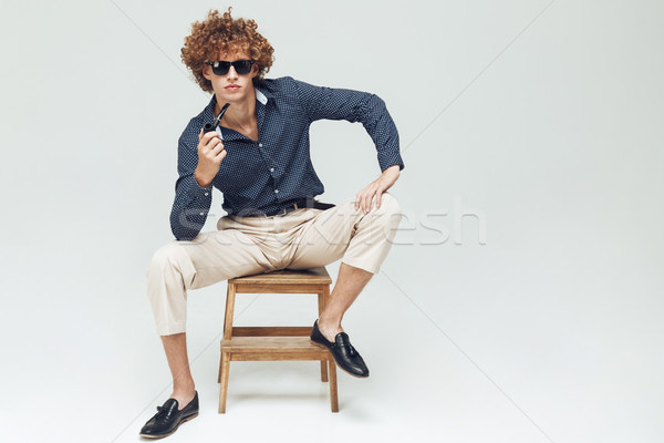 Retro man dressed in shirt sitting and posing Stock photo © deandrobot
