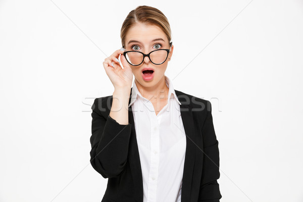 Stock photo: Shocked blonde business woman looking at camera with open mouth