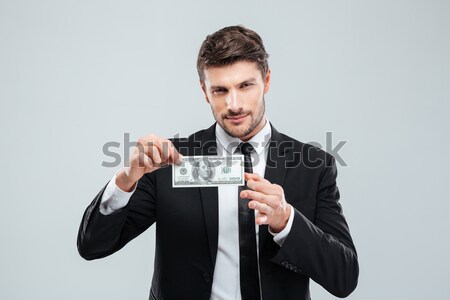 Jóképű fiatal pincér tart pénz fotó Stock fotó © deandrobot