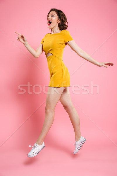 Full length photo of pretty girl with red lips makeup pointing w Stock photo © deandrobot
