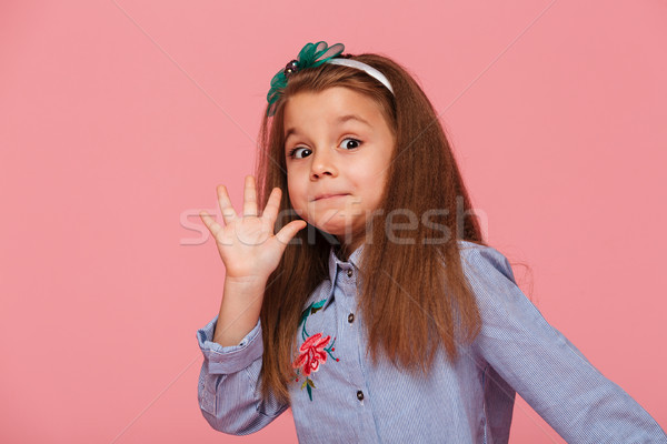 Portrait of funny female kid having long auburn hair looking on  Stock photo © deandrobot