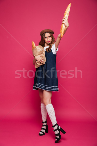 Vicces hölgy kék ruha tart francia kenyér Stock fotó © deandrobot
