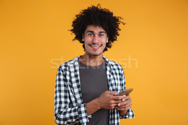 Portrait of a happy cheery african man Stock photo © deandrobot