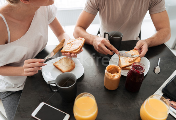 Cropped image of couple have tasty breakfast in the kitchen Stock photo © deandrobot