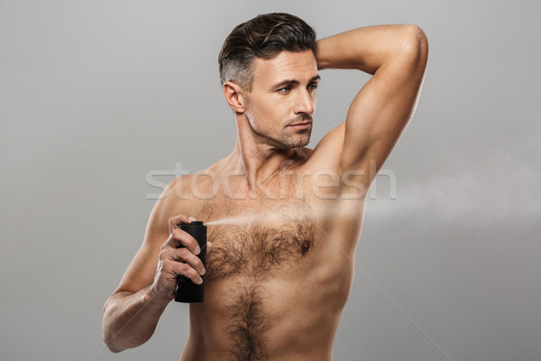 érett férfi áll tart dezodor kép jóképű Stock fotó © deandrobot