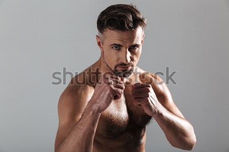 Portrait of a muscular man keeping his palms by face Stock photo © deandrobot
