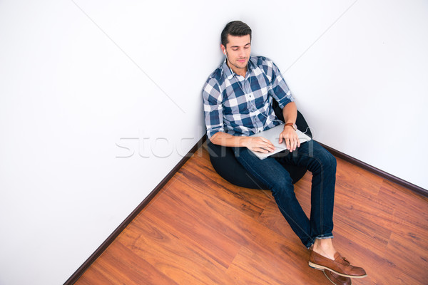 Casual man relaxing on the bag chair  Stock photo © deandrobot