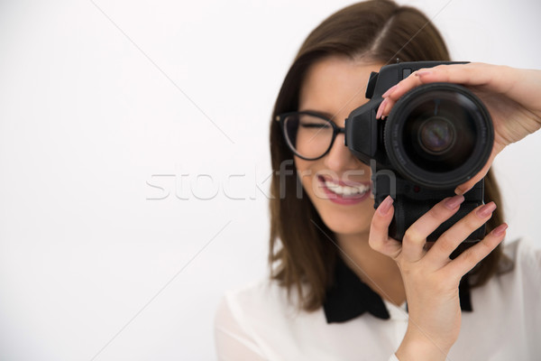 Cheerful female photographer with camera over gray background Stock photo © deandrobot