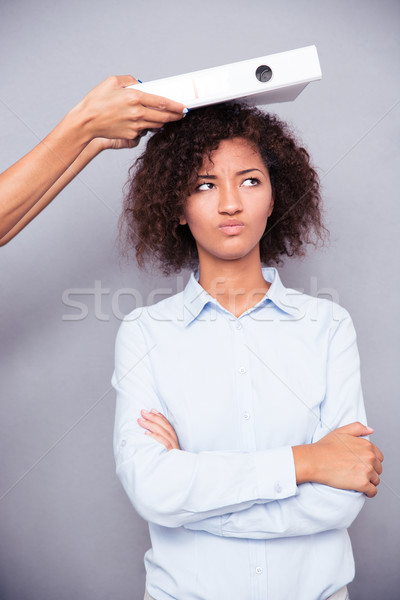 Offended afro american woman stnading with arms folded Stock photo © deandrobot
