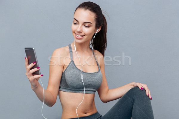 Close-up portrait of a girl doing yoga listening music Stock photo © deandrobot