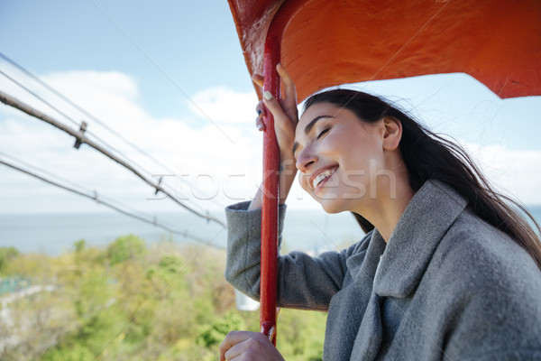 Happy young cheerful girl having fun outdoors Stock photo © deandrobot