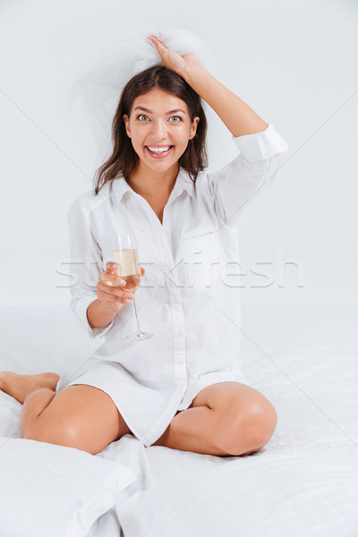 Happy women wearing bridal veil and holding glass with champagne Stock photo © deandrobot