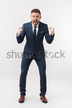 Angry young bearded businessman showing his watch. Stock photo © deandrobot