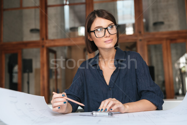 Thoughtful business woman in eyeglasses Stock photo © deandrobot