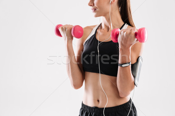 画像 やる気のある フィットネス女性 スポーツウェア 音楽を聴く イヤホン ストックフォト © deandrobot