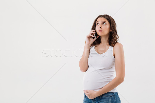Sad pregnant woman isolated talking by mobile phone Stock photo © deandrobot