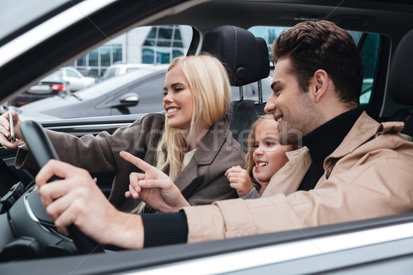 Happy young family make selfie by mobile phone. Stock photo © deandrobot