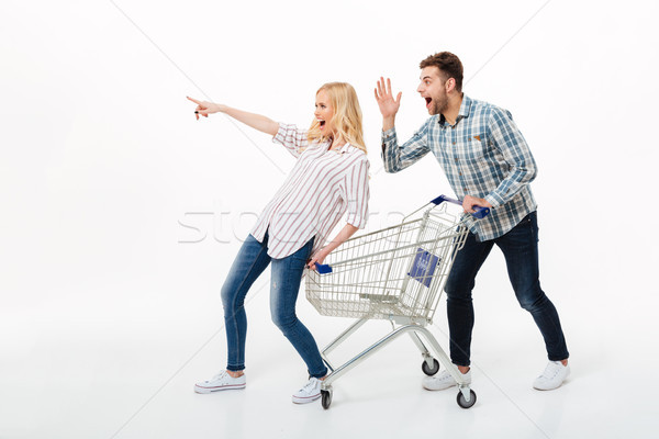 Full length portrait of an excited couple Stock photo © deandrobot