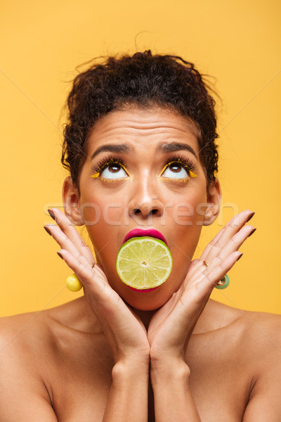 Vertical image of cute afro american woman with trendy makeup ho Stock photo © deandrobot