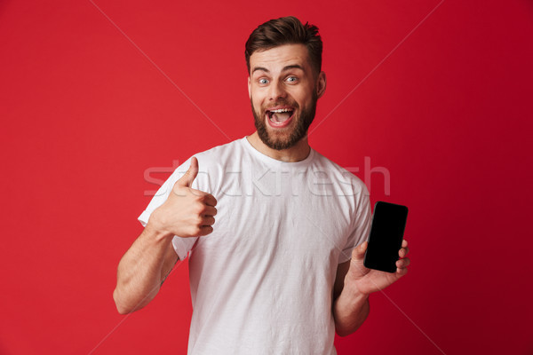 Glücklich junger Mann Display Handy Erzeugnis Stock foto © deandrobot