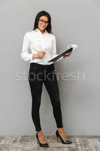 Full length image of lovely woman wearing businesslike outfit an Stock photo © deandrobot