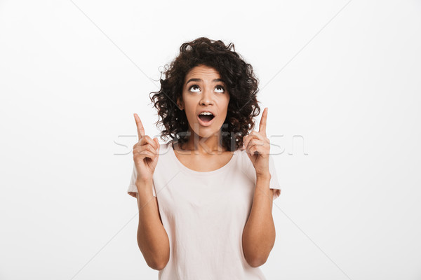 Portrait of american woman in basic t-shirt with curly hair look Stock photo © deandrobot