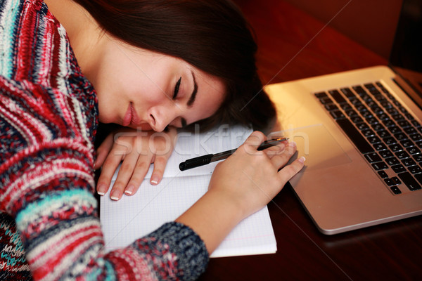 Tired woman sleeping on the table at home Stock photo © deandrobot
