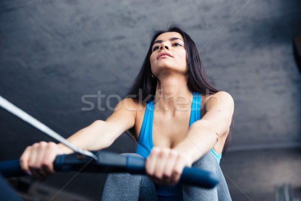 Woman working out on training simulator Stock photo © deandrobot