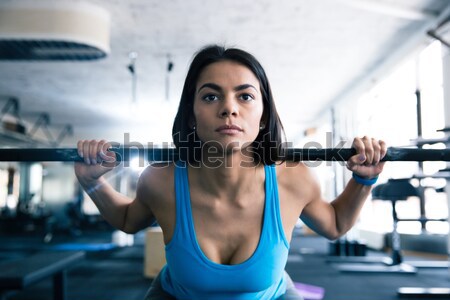 Stock photo: Beautiful woman working out with barbell